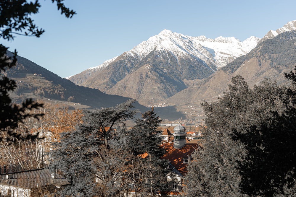 a view of a mountain range with houses in the foreground