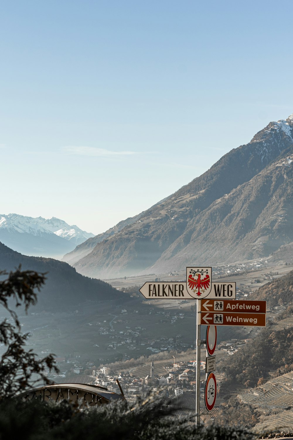 a street sign with a mountain in the background