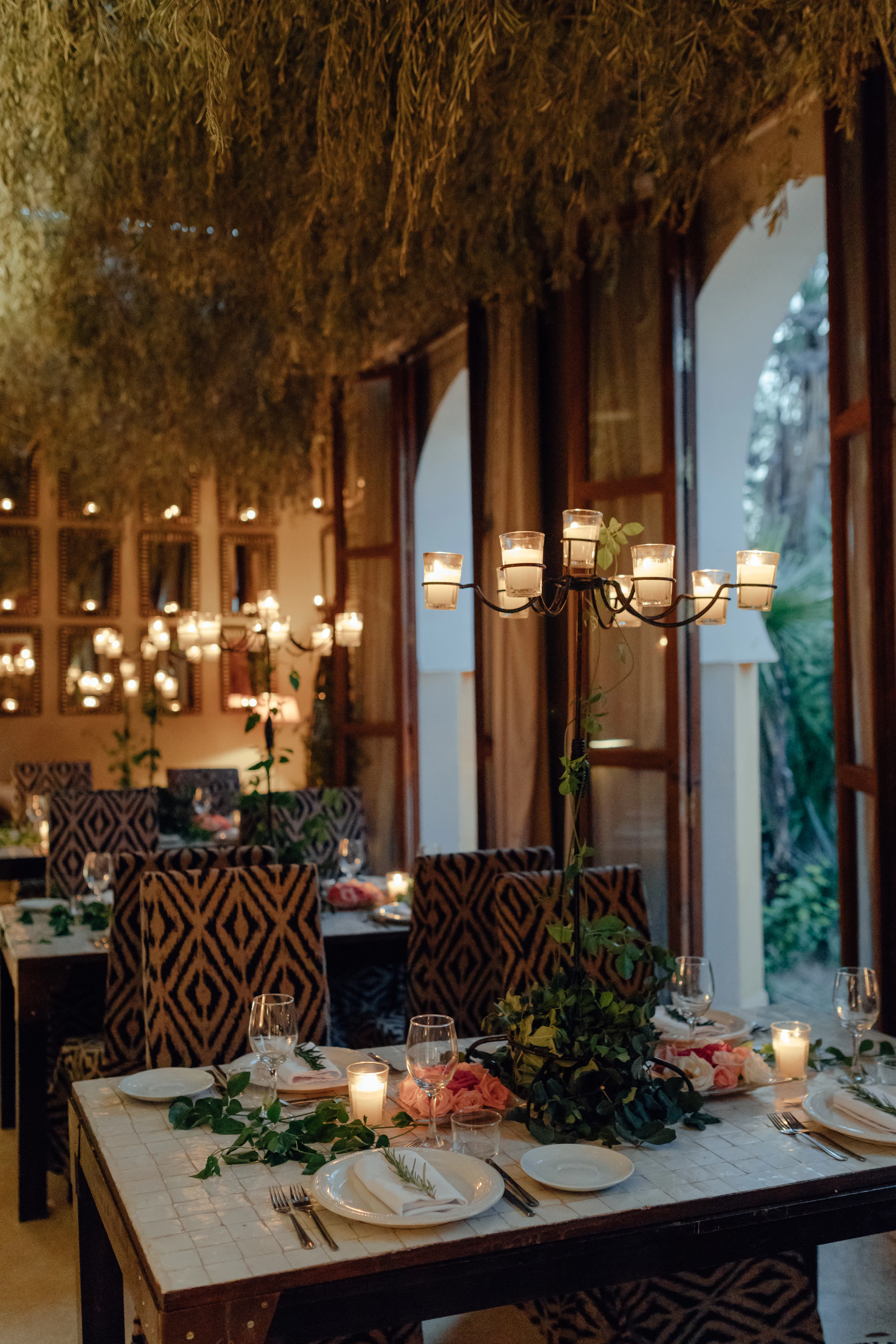 A modern table set for an evening dinner with candlelight