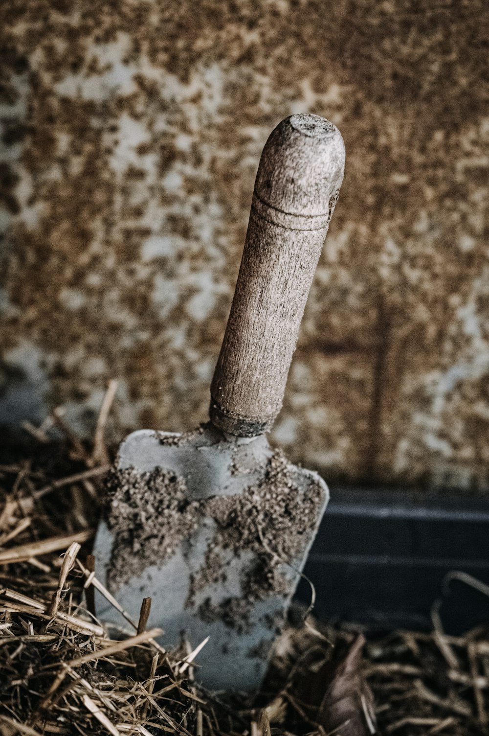 a shovel sitting in a pile of hay