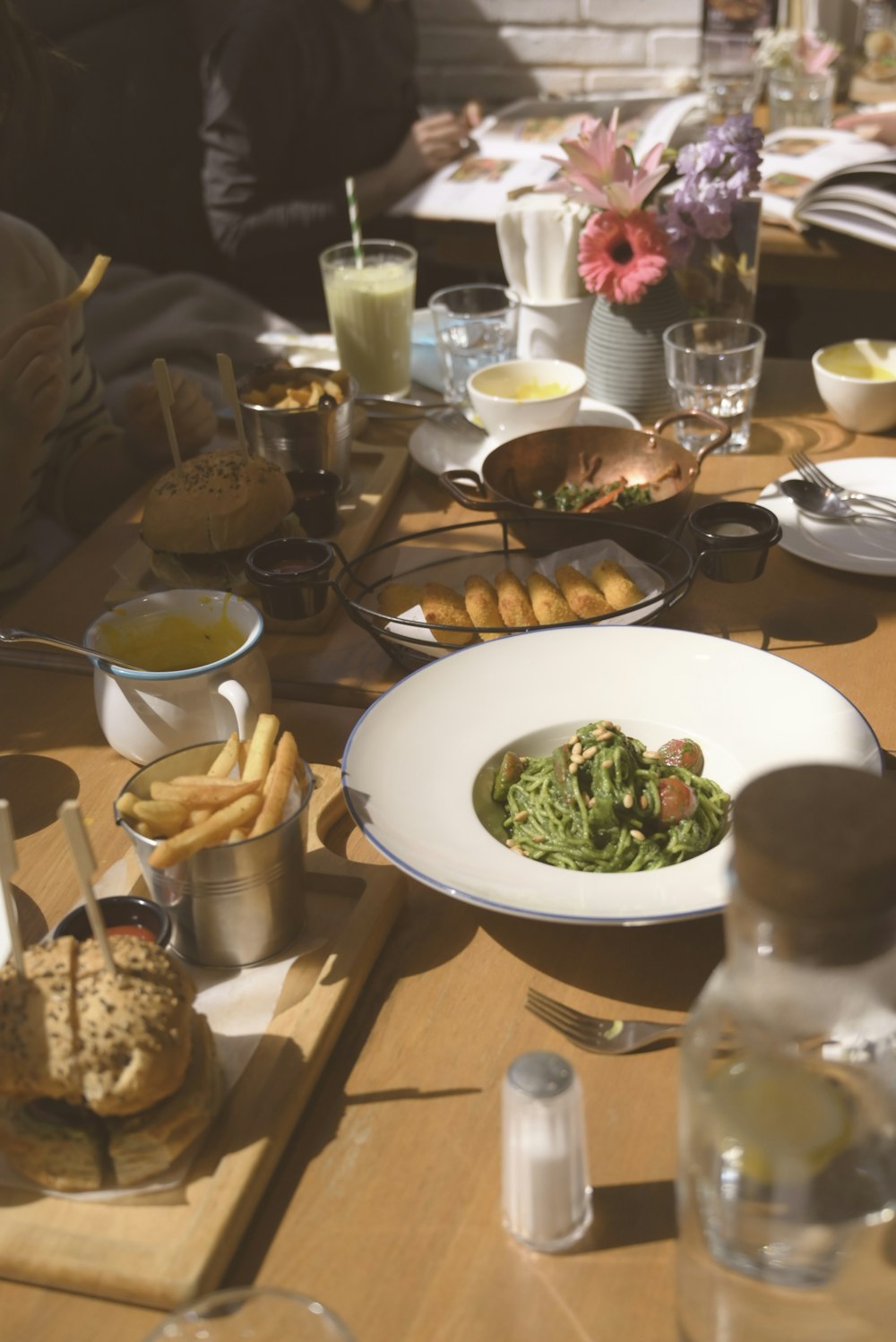 a wooden table topped with plates of food