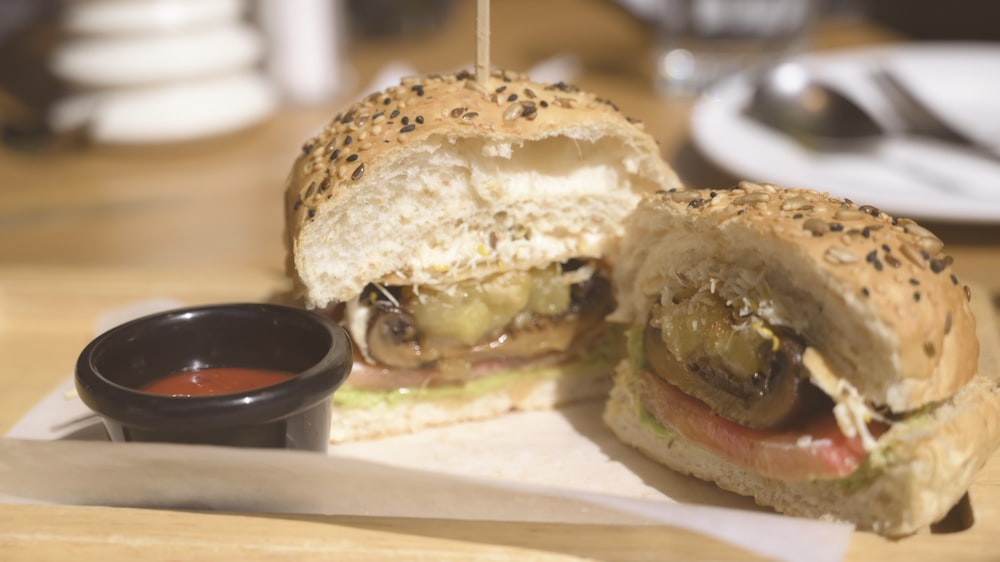 a cut in half sandwich sitting on top of a cutting board