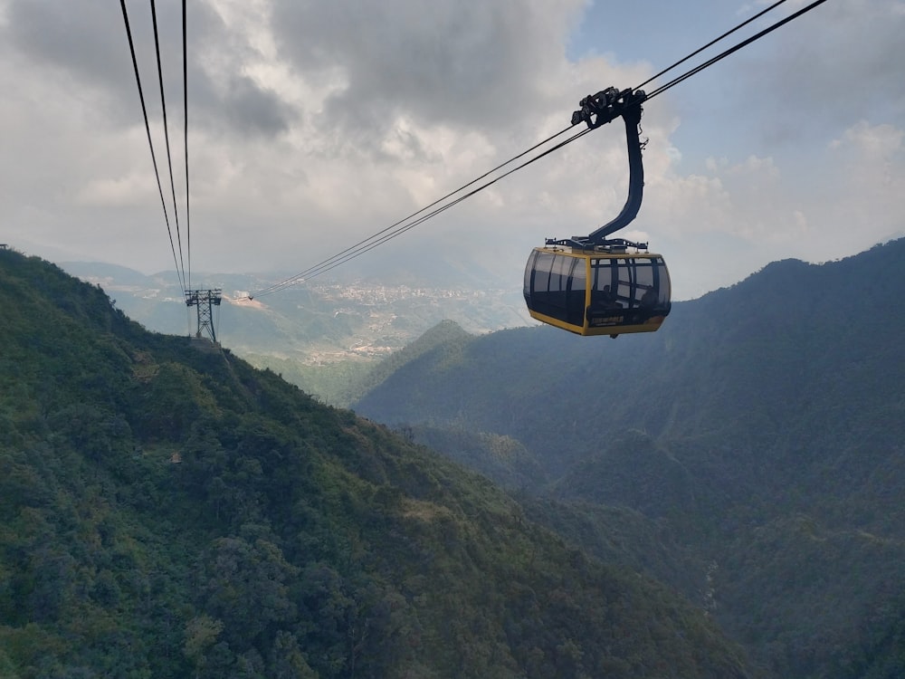 a cable car going up a mountain side