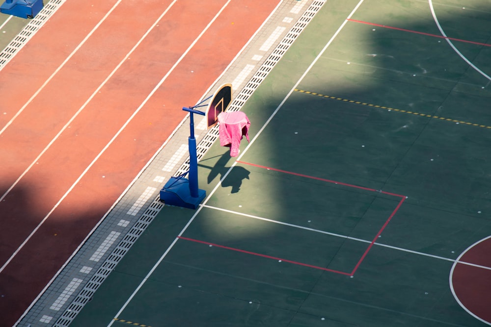 a woman in a pink shirt standing on a basketball court
