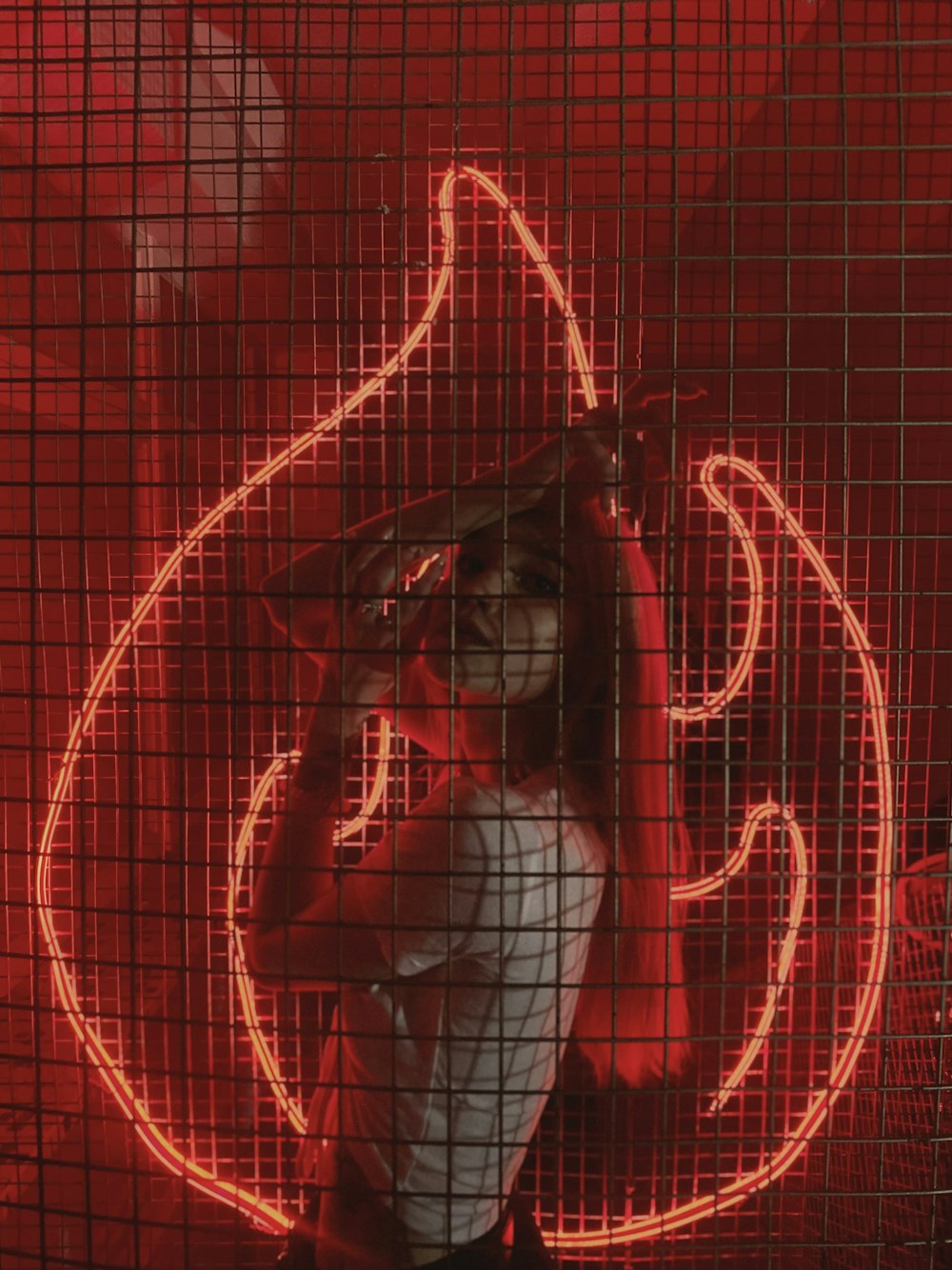 a baseball player holding a bat in front of a neon sign