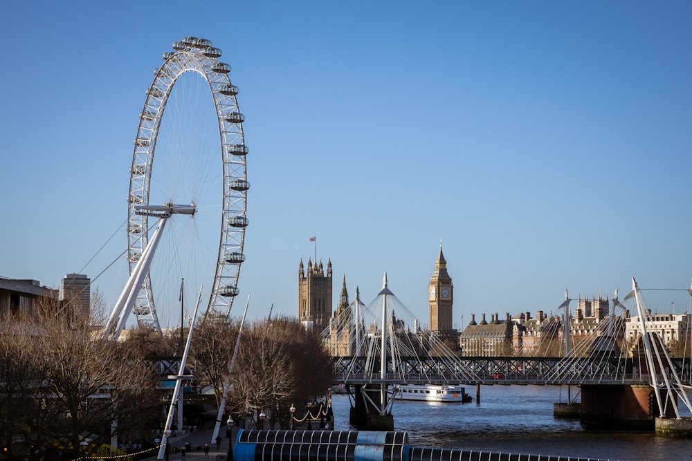 a large ferris wheel sitting in the middle of a river