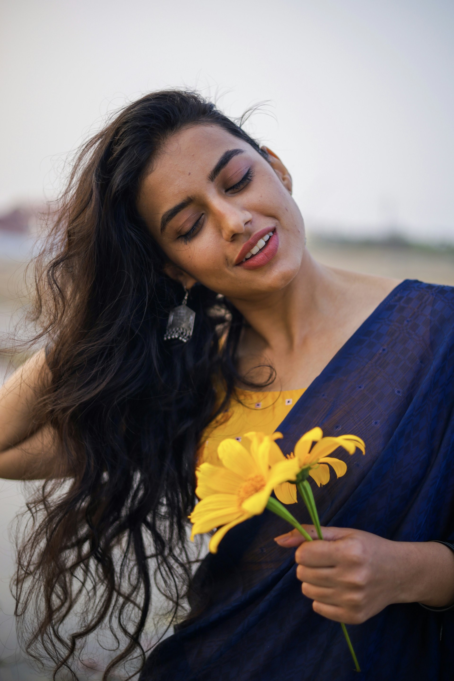 woman wearing yellow long-sleeved dress under white clouds and blue sky during daytime