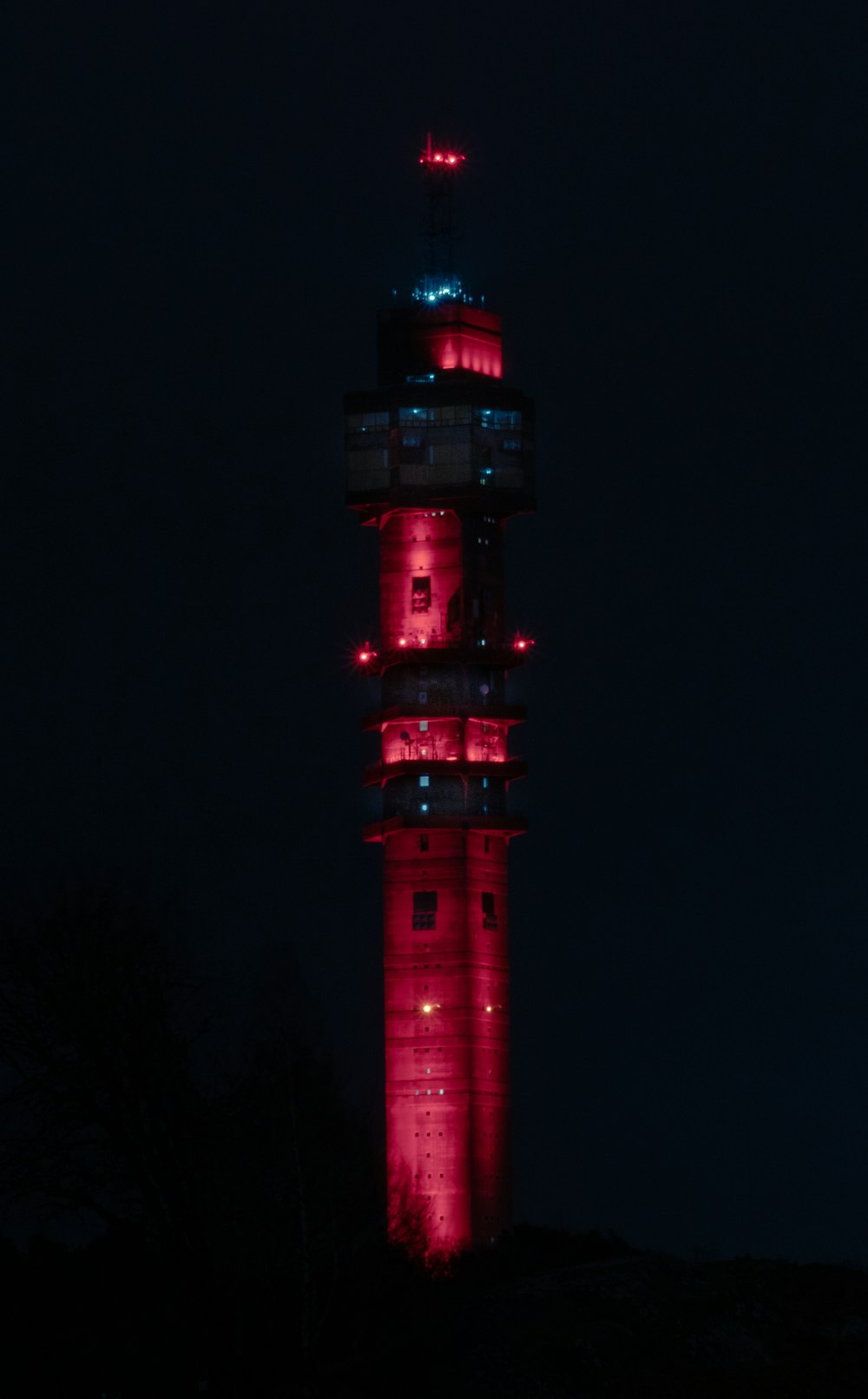 a tall tower with a red light on top of it