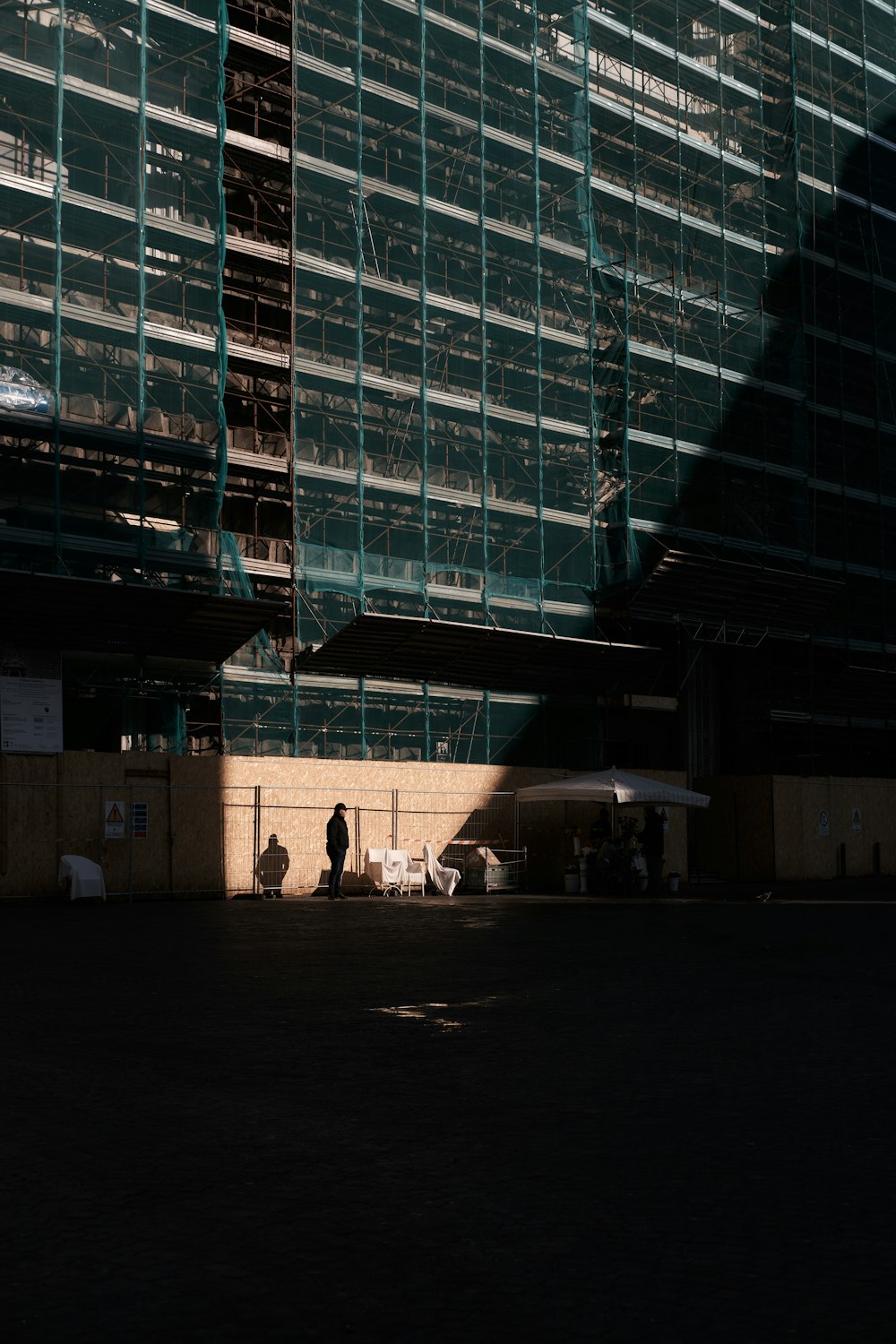 a person standing in front of a tall building