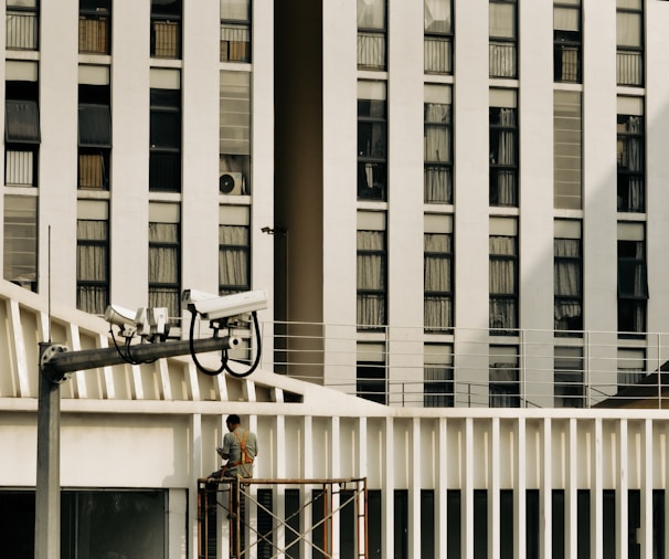Wide shot of a multi-level commercial building with GPR scanning equipment set up