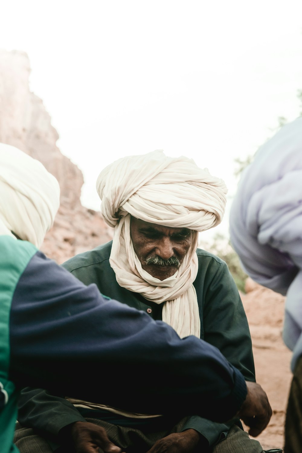 a group of people standing around each other