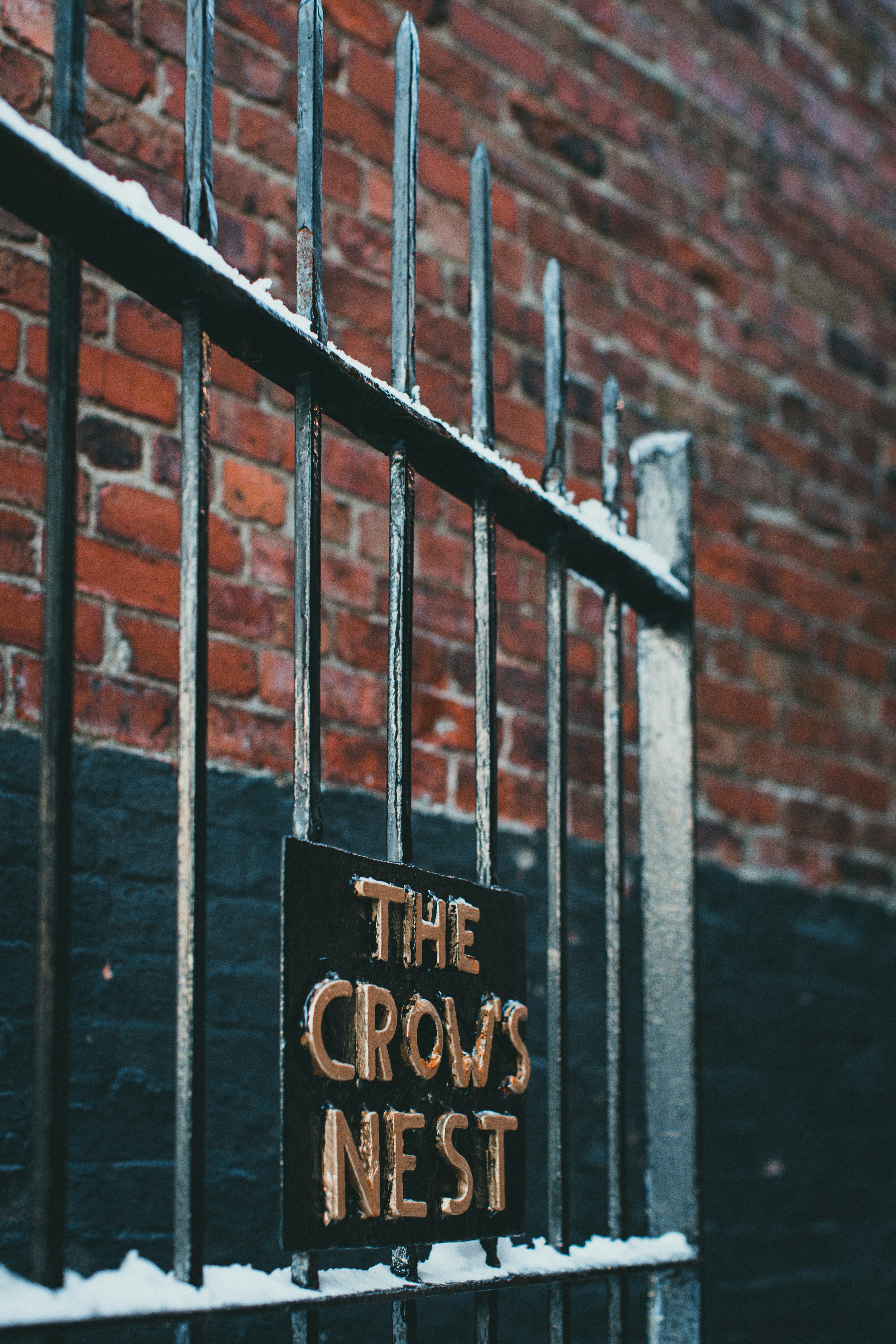 A sign that reads the crow's nest on a gate photo – Free Grey Image on ...