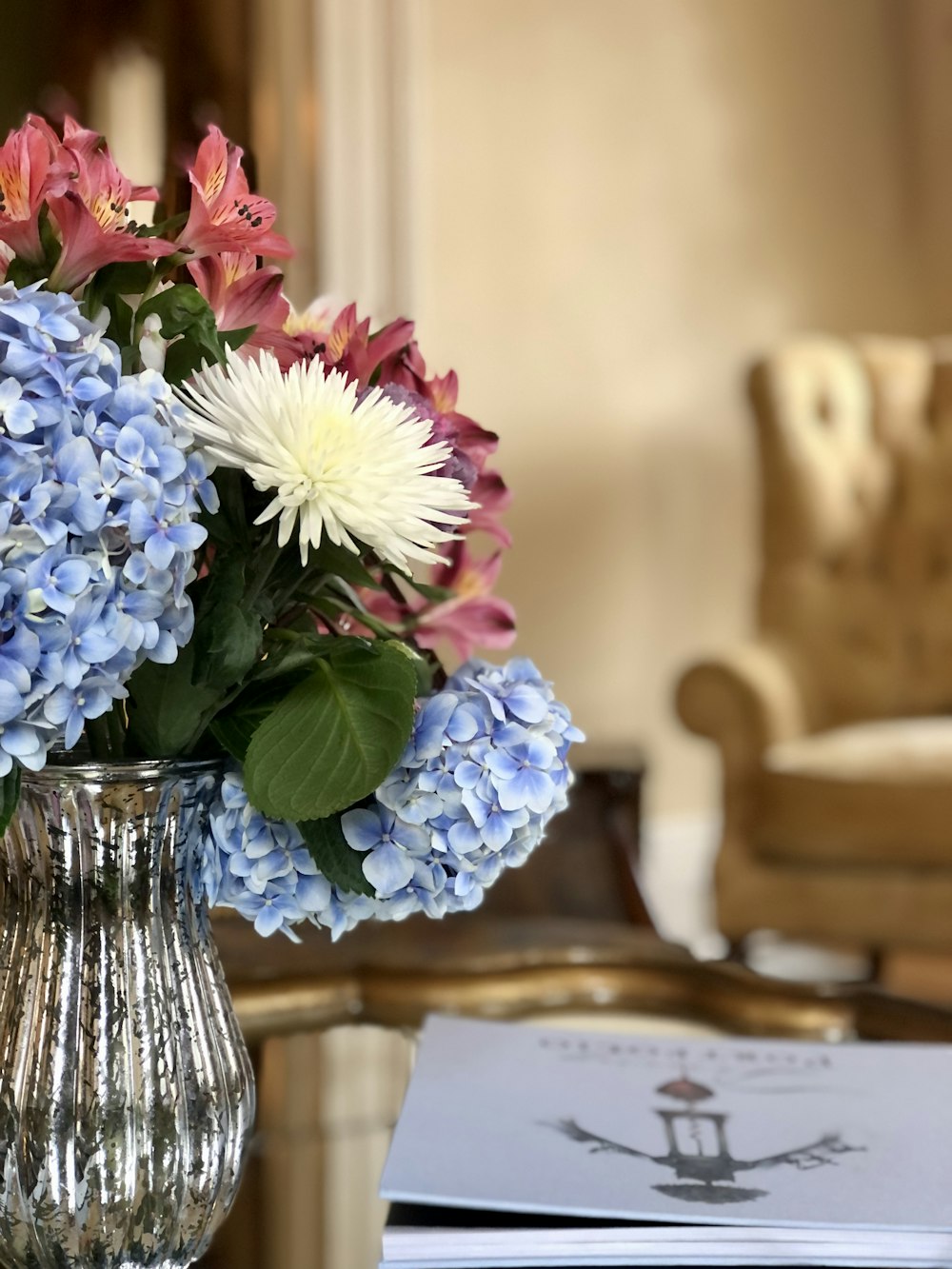 a vase filled with flowers sitting on top of a table