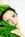 a woman with blue eyes and a green plant
