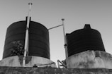 a black and white photo of two large tanks