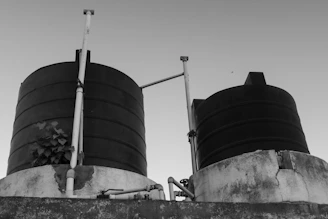a black and white photo of two large tanks