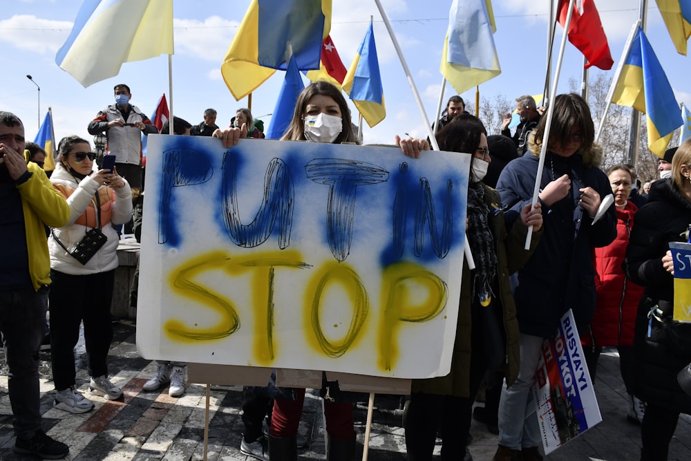 a group of people holding signs and flags