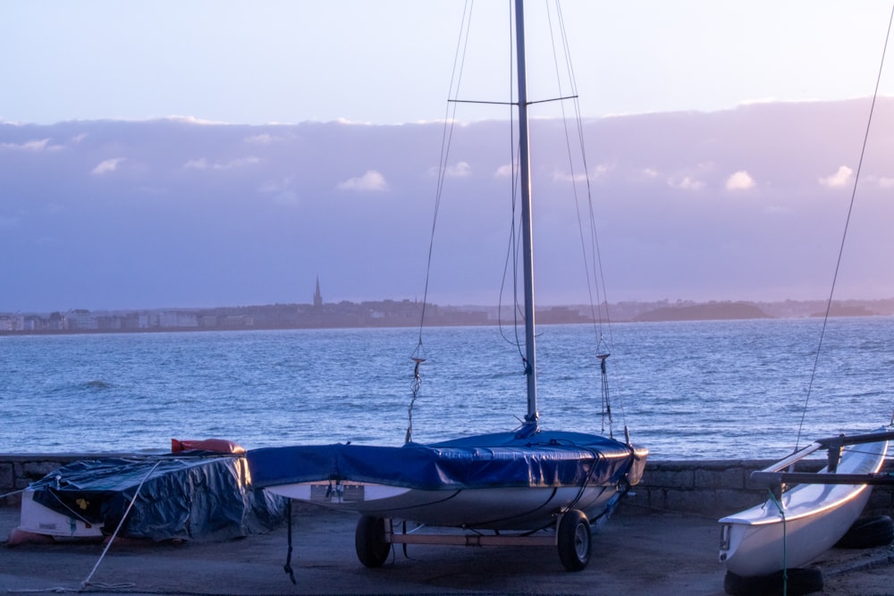 a couple of boats sitting on top of a beach