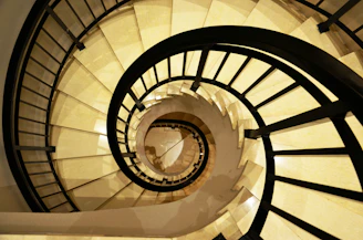 a spiral staircase in a building with white walls