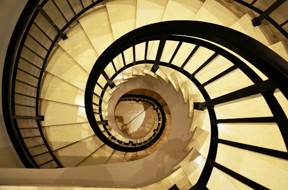 a spiral staircase in a building with white walls