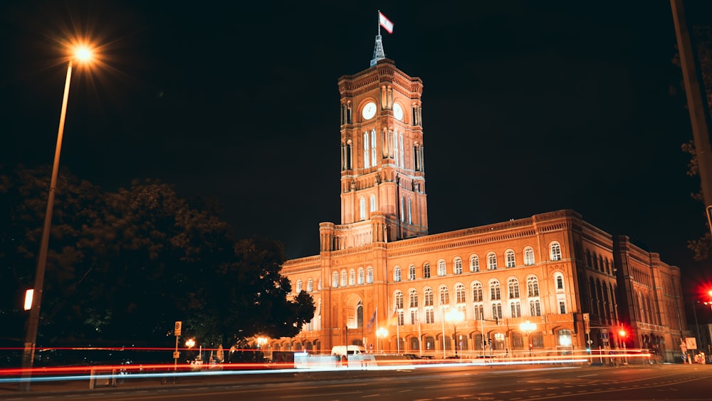 a large building with a clock tower at night