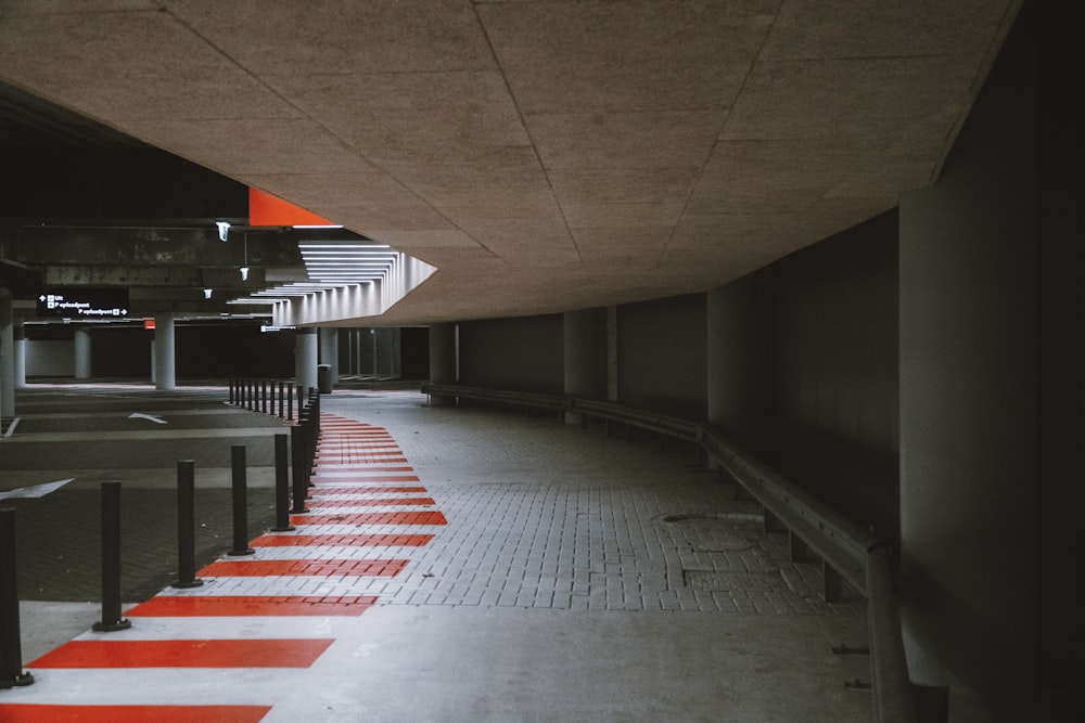 an empty parking garage with red and white stripes