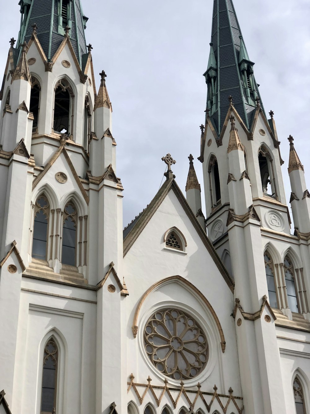 a large white church with two towers and a clock