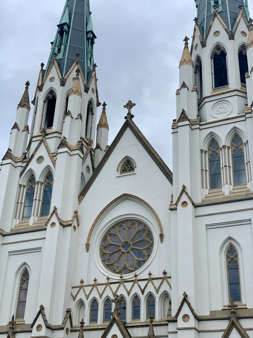 a large white church with two towers and a clock