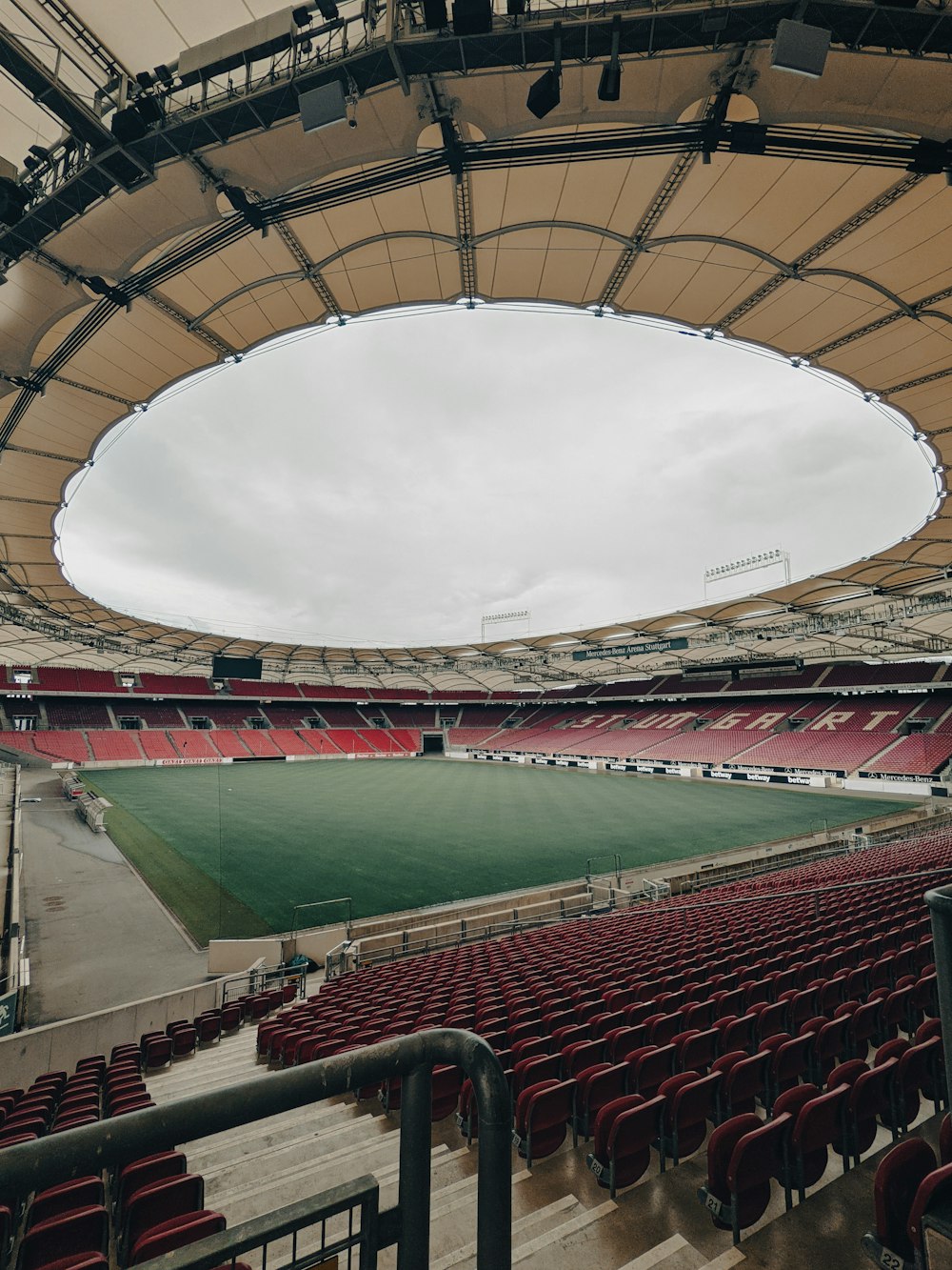 a large empty stadium with red seats