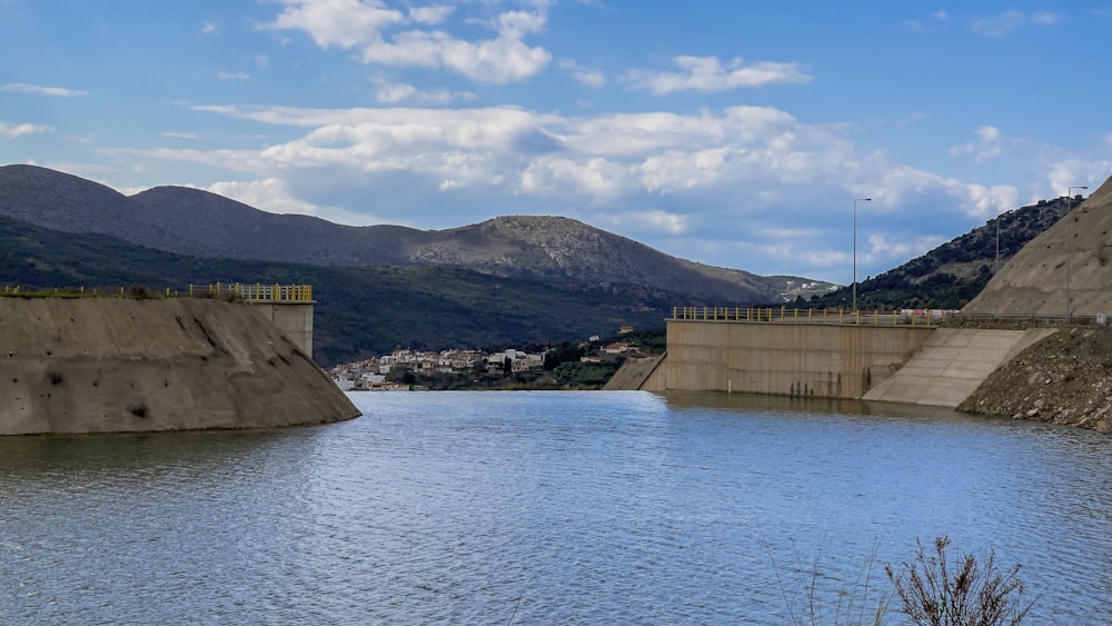 a large body of water with mountains in the background