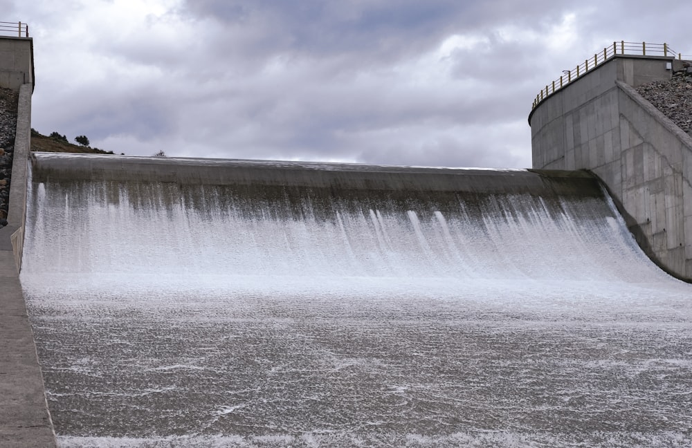 a large dam with water coming out of it