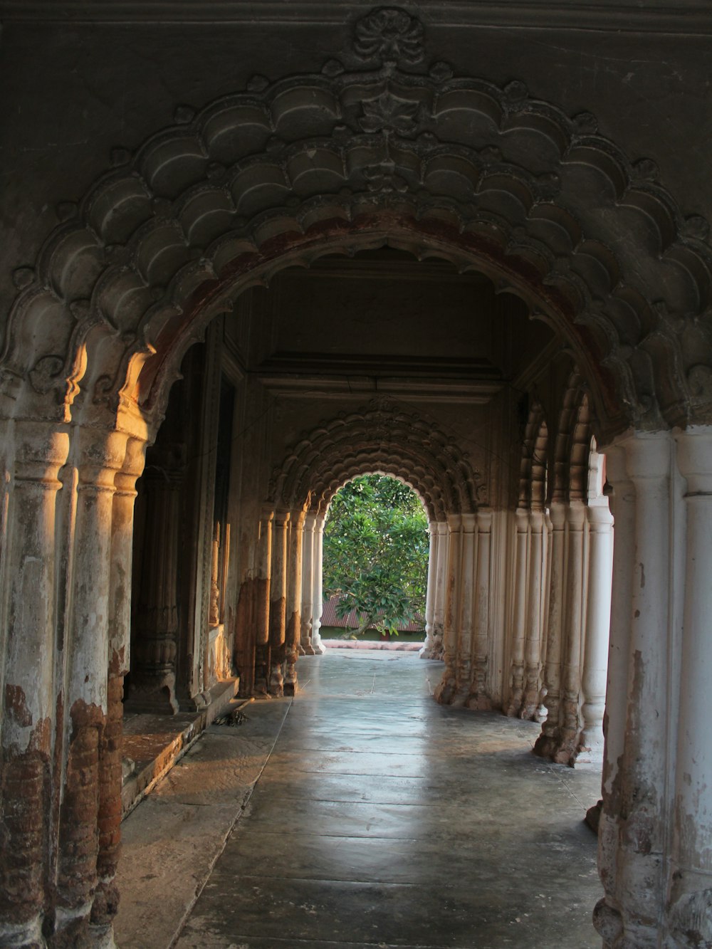 an archway in a building with a clock on the wall