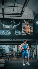 a man standing in a gym holding a frisbee