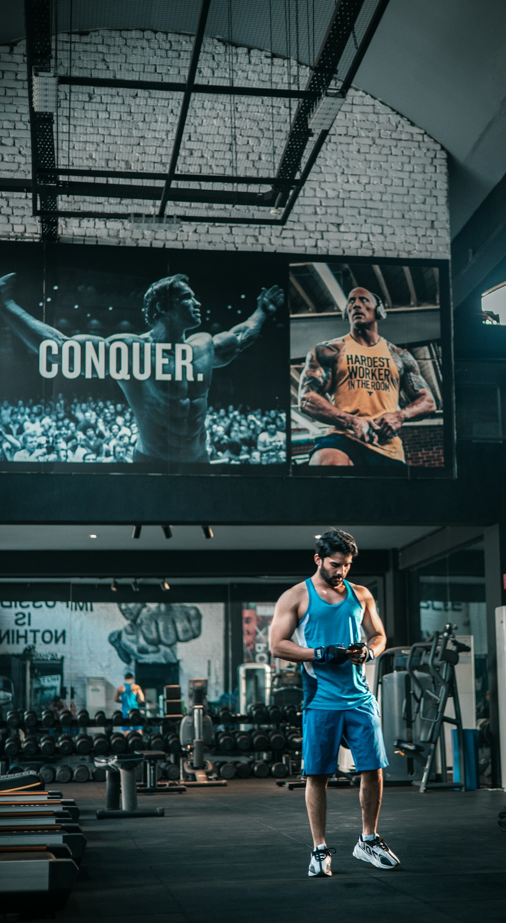 a man standing in a gym holding a frisbee