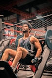 a man sitting on a bench in a gym