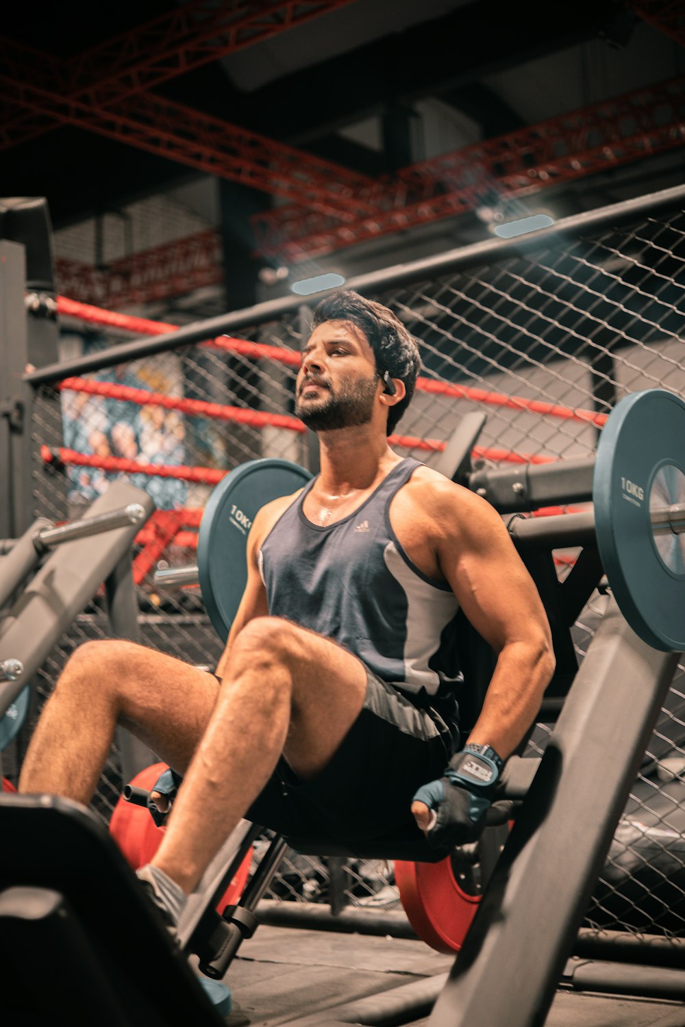 a man sitting on a bench in a gym