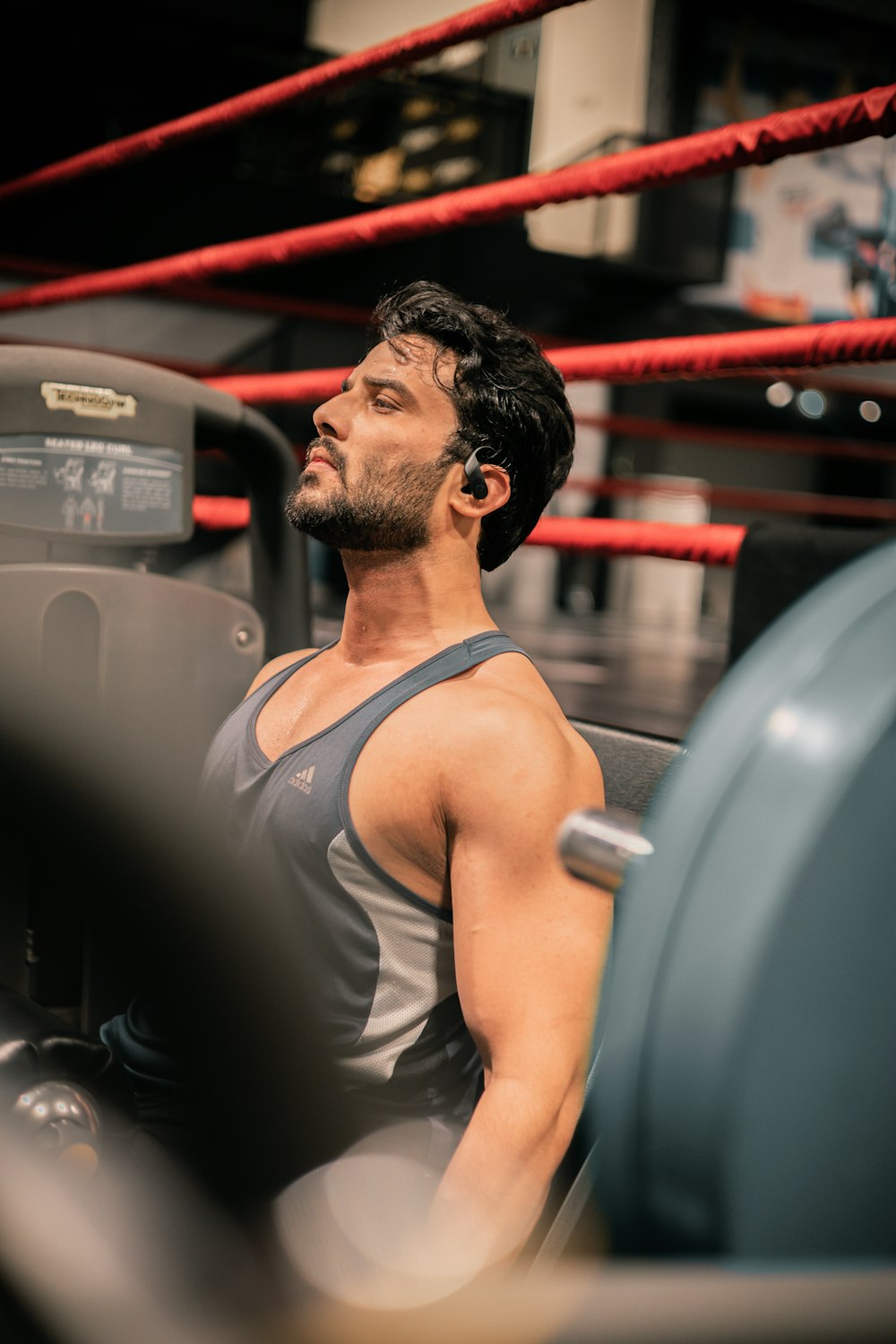 a man sitting on a bench in a gym