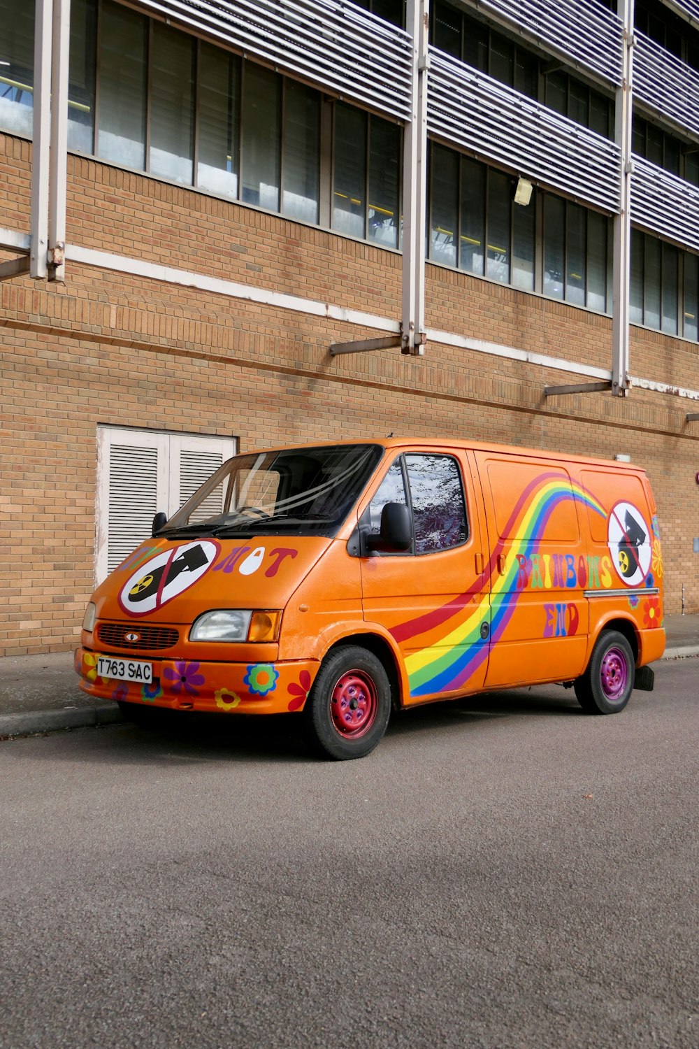 an orange van parked on the side of the road