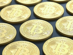 a pile of gold bitcoins sitting on top of a table
