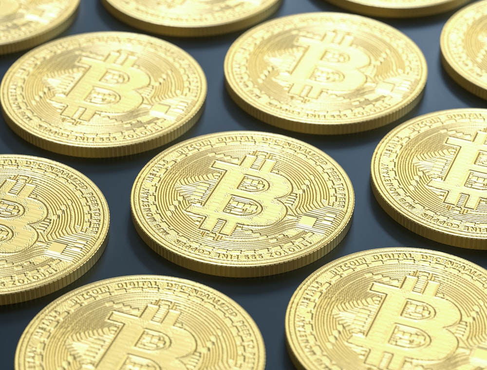 a pile of gold bitcoins sitting on top of a table