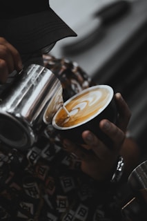 a person is holding a cup of coffee
