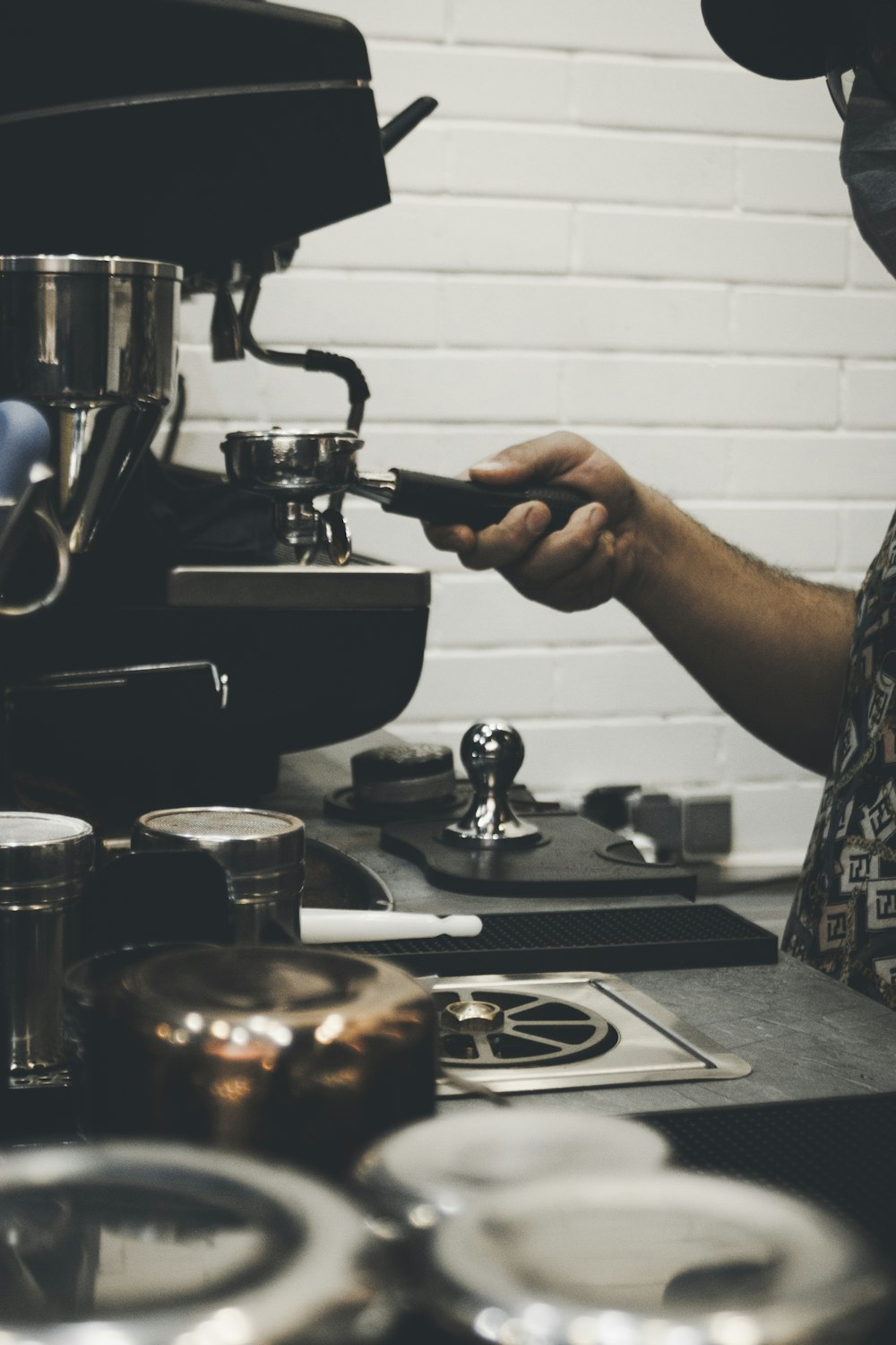 a man is making a cup of coffee