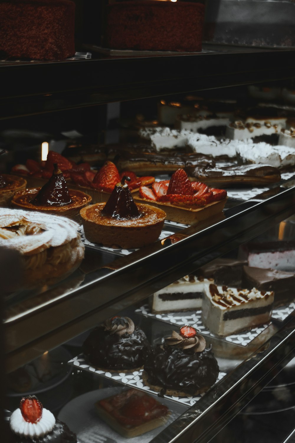 a display case filled with lots of different types of cakes