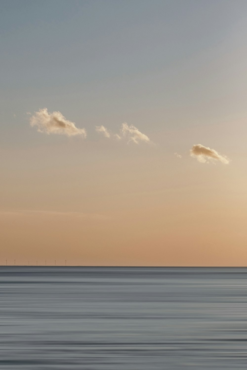 a large body of water sitting under a cloudy sky