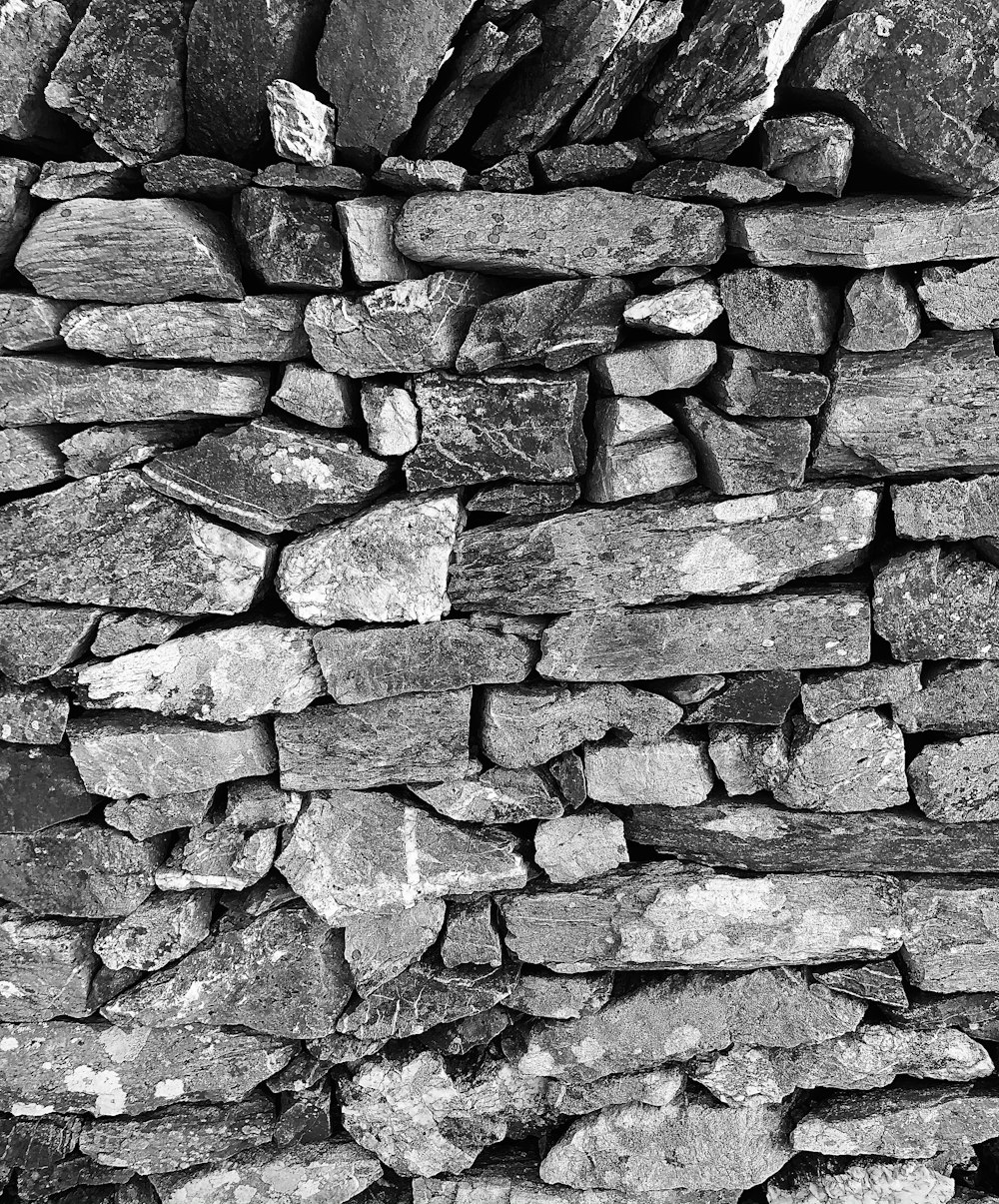 a black and white photo of a stone wall