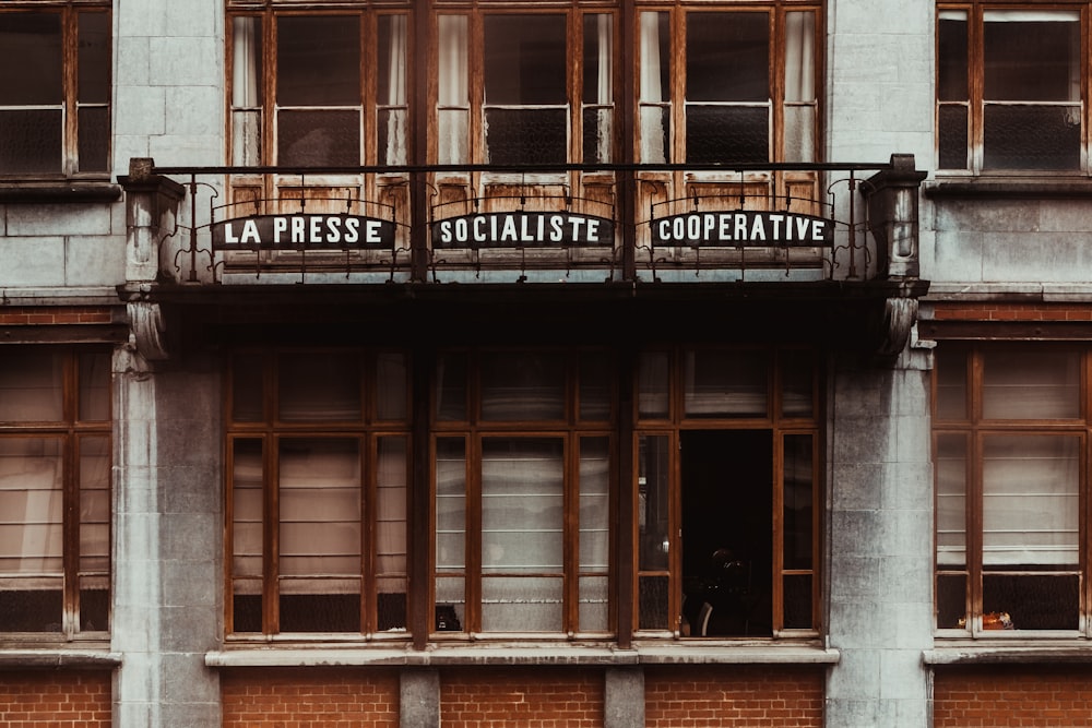 a tall building with a balcony and windows