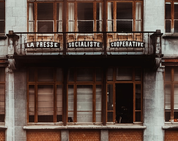 a tall building with a balcony and windows