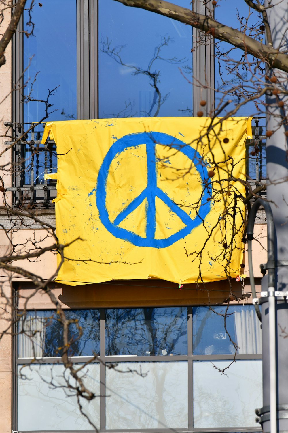 a peace sign is hanging on a building