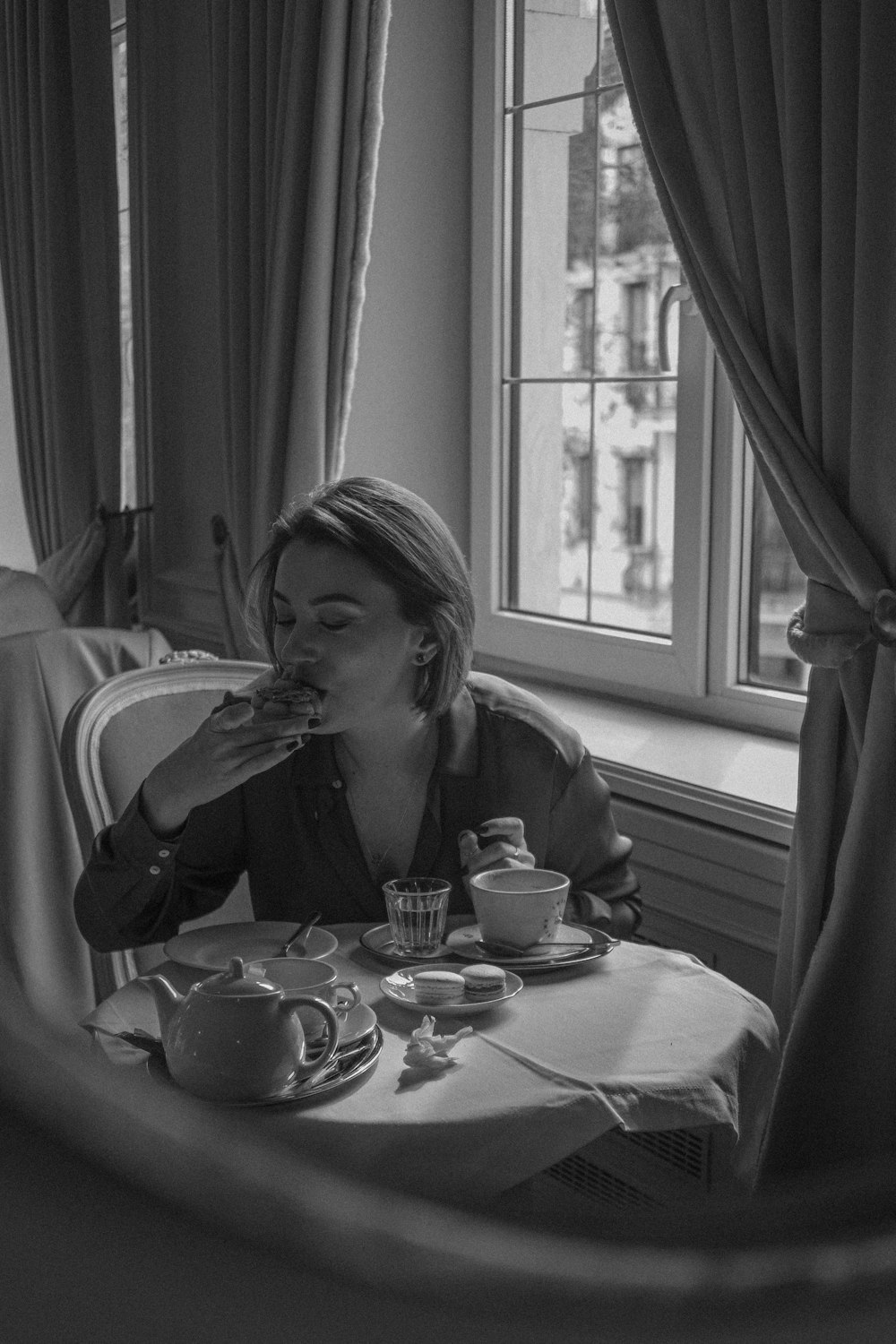 a woman sitting at a table eating food