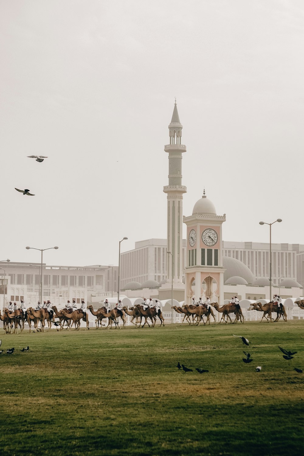 a group of people riding horses in front of a building